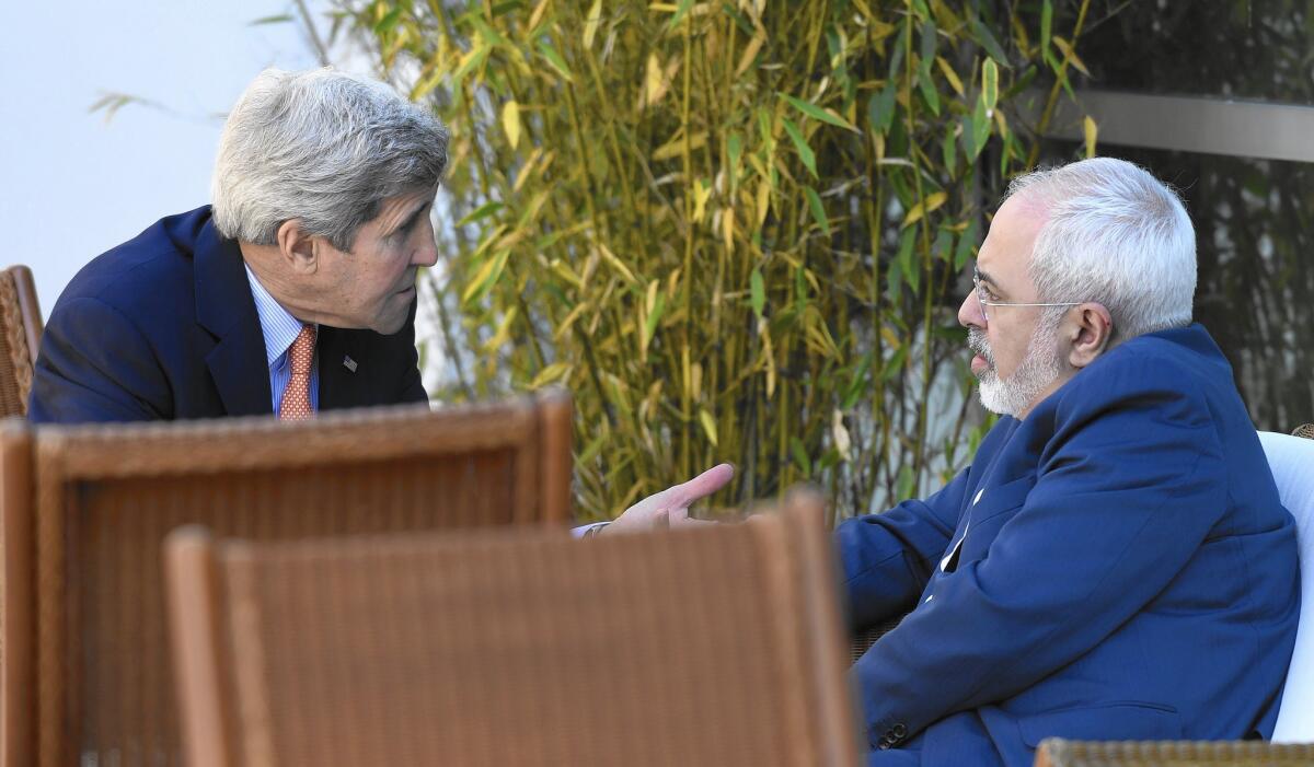U.S. Secretary of State John F. Kerry, left, speaks with Iranian Foreign Minister Mohammad Javad Zarif in Geneva last month.