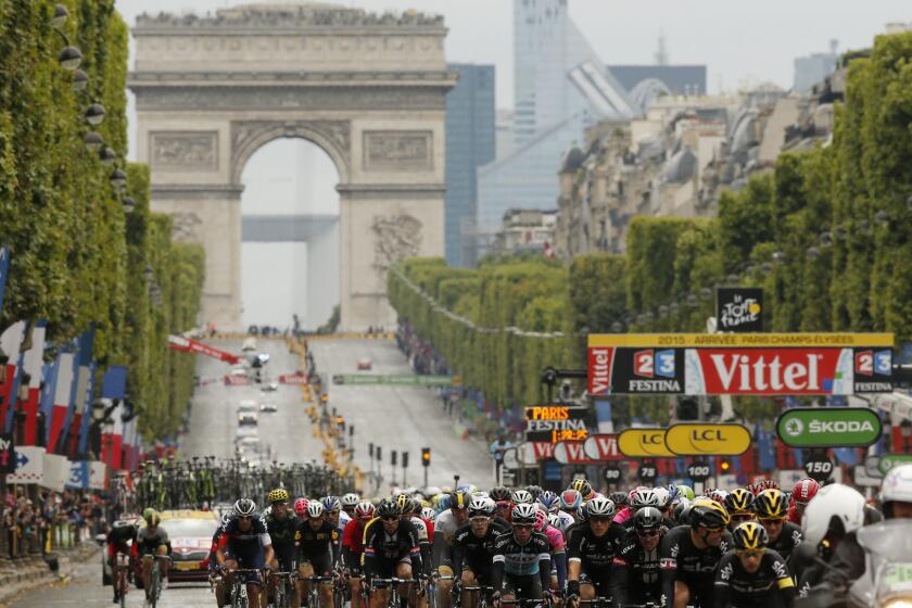 The peloton rides in front of the Arc de Triomphe during the final stage of the Tour de France in Paris on July 26, 2015.