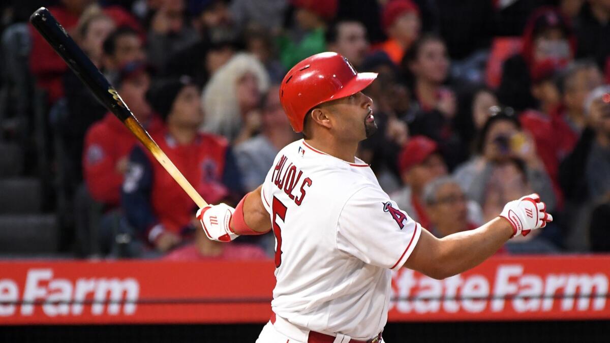 Albert Pujols hits a solo home run against Orioles pitcher Dylan Bundy in the first inning Tuesday night at Angel Stadium.