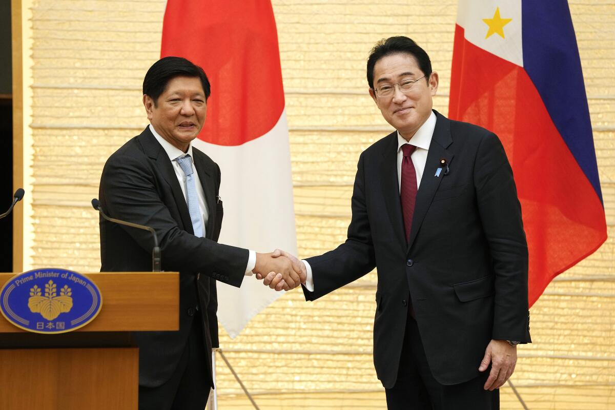 Philippine President Ferdinand Marcos Jr., left, and Japanese Prime Minister Fumio Kishida conclude their joint press remarks after their talks at prime minister's official residence in Tokyo, Thursday, Feb. 9, 2023. (Kimimasa Mayama/Pool Photo via AP)
