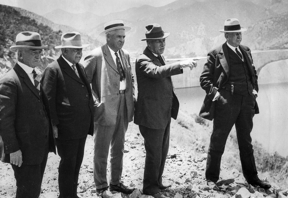 Circa 1926 photo of officials at the site of the new St. Francis Dam. Dam builder William Mulholland, pointing, with water officials, from left, Fred Fischer, R.F. Del Valle, Janus Baker and Dr. John Haynes.
