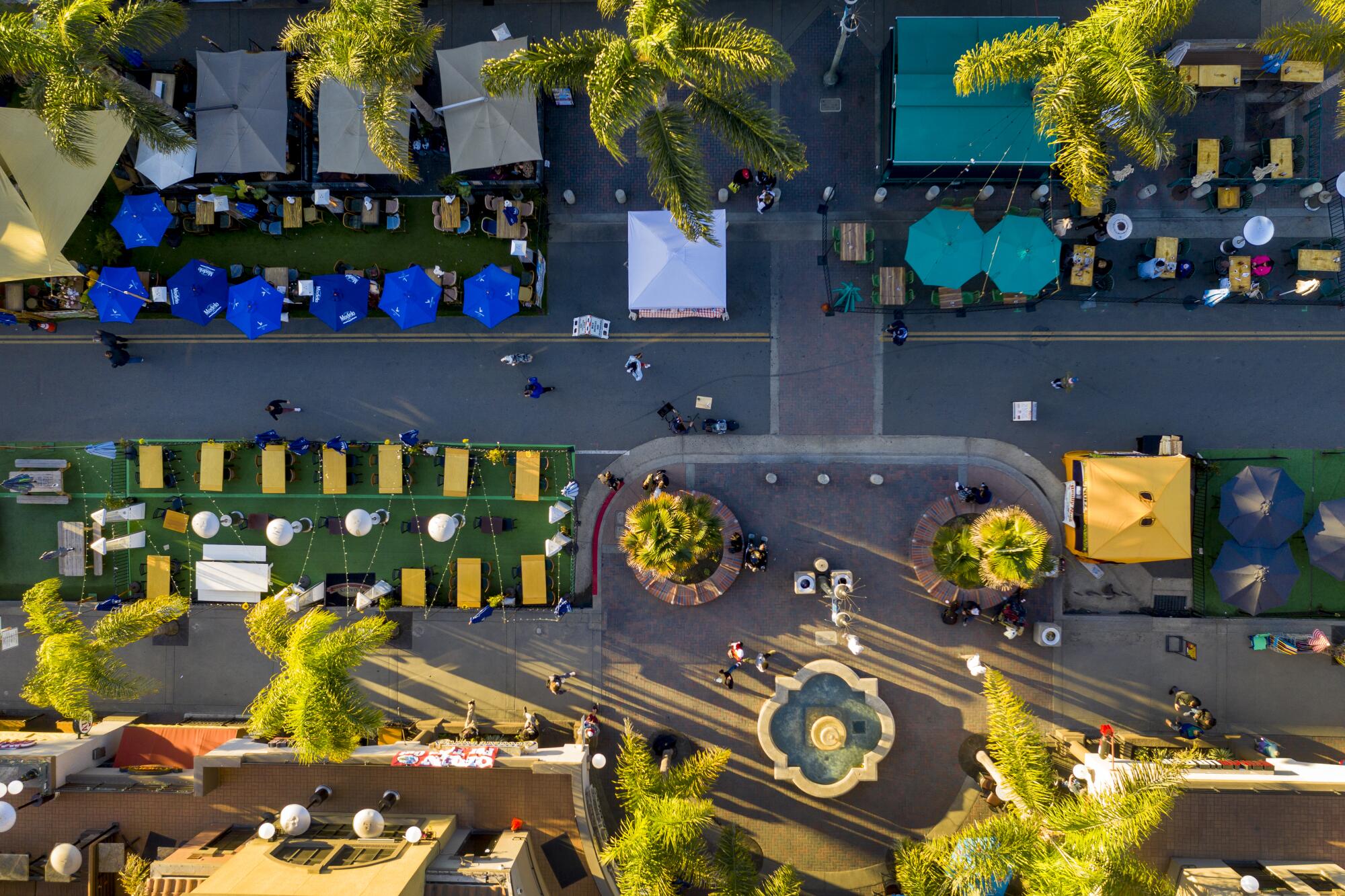 An aerial view of people dining at restaurants on Main Street in Huntington Beach in 2021. 