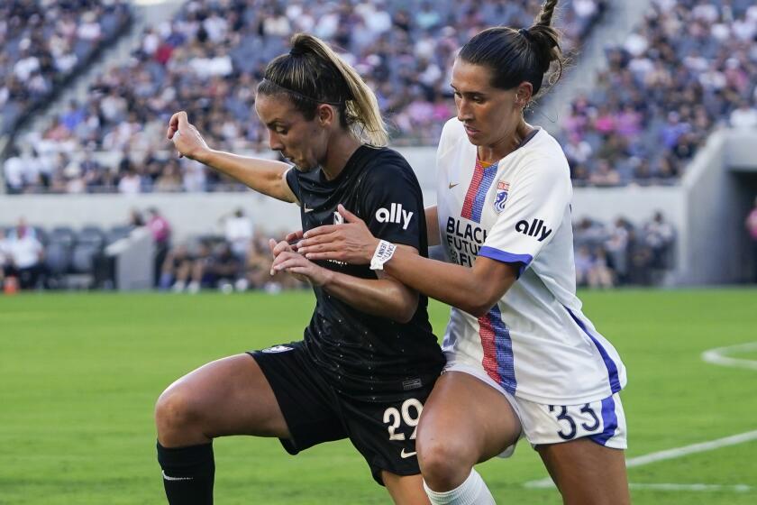 Angel City FC midfielder Clarisse Le Bihan (29) controls the ball as OL Reign.