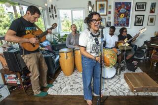 LOS ANGELES, CA-JULY 26, 2023: left to right-Quetzal Flores, Alberto Lopez, Dr. Martha Gonzalez, Evan Greer, and Juan Perez, members of the band Quetzal, rehearse in Los Angeles. The Grammy-winning East L.A. band has been one of the most innovative Chicano rock groups of the last three decades, fusing rock, R&B and regional Mexican music into a style that is alternately poetic and defiant. They're being honored with a 30th anniversary concert on August 19 at la Plaza de Cultural y Artes in downtown Los Angeles. (Mel Melcon / Los Angeles Times)