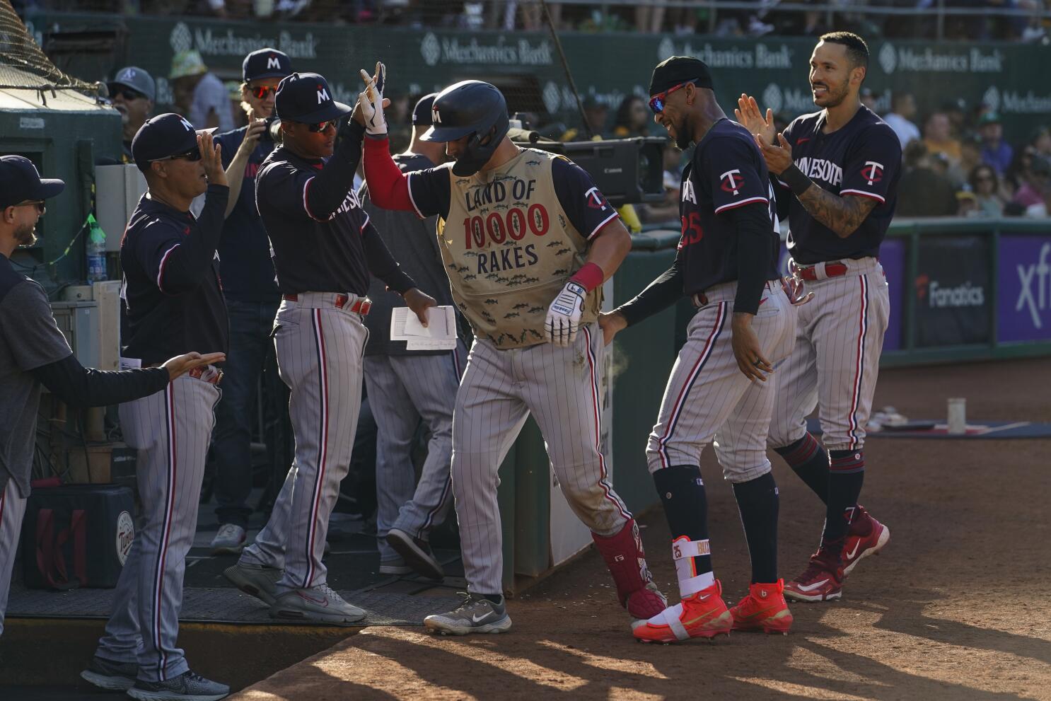 Carlos Perez of the Oakland Athletics celebrates in the dugout