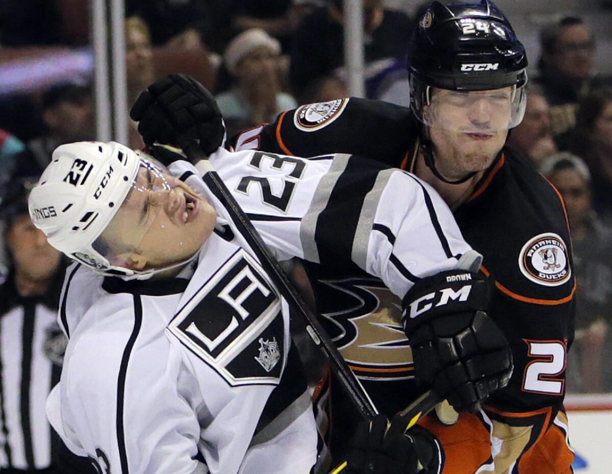 Ducks defenseman Simon Despres, right, gets called for high-sticking against Kings right wing Dustin Brown on March 18.
