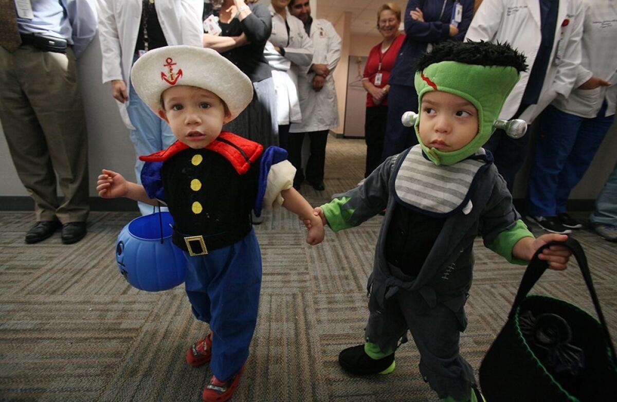 Popeye, aka Ian Garzon, one year old, towed his friend Frankenstein, aka Samuel Huerta, 2, past a line of adoring doctors, nurses and technicians Thursday in search of spinach-flavored Halloween candy.