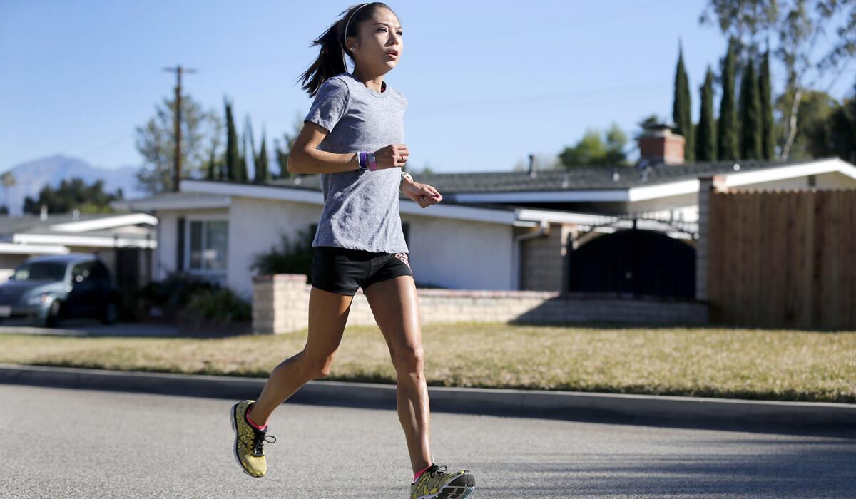 Lenore Moreno, a marathon runner, trains near her West Covina home on Tuesday before competing in the Olympic Trials Marathon this weekend.