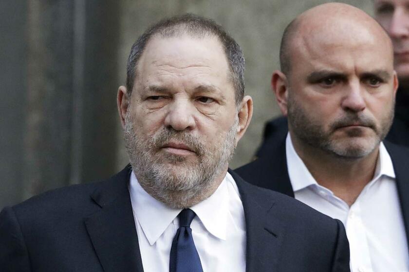 FILE - In this Thursday, Dec. 20, 2018, file photo, Harvey Weinstein, center, leaves New York Supreme Court in New York. Weinsteins lawyers say a New York judge should reject sex trafficking claims in a class-action civil lawsuit against the movie mogul. The lawyers said in papers filed late Monday, Jan. 28, that the law was aimed at stopping sex-trafficking rings or ventures that profit from the illicit sex trade. (AP Photo/Mark Lennihan, File)