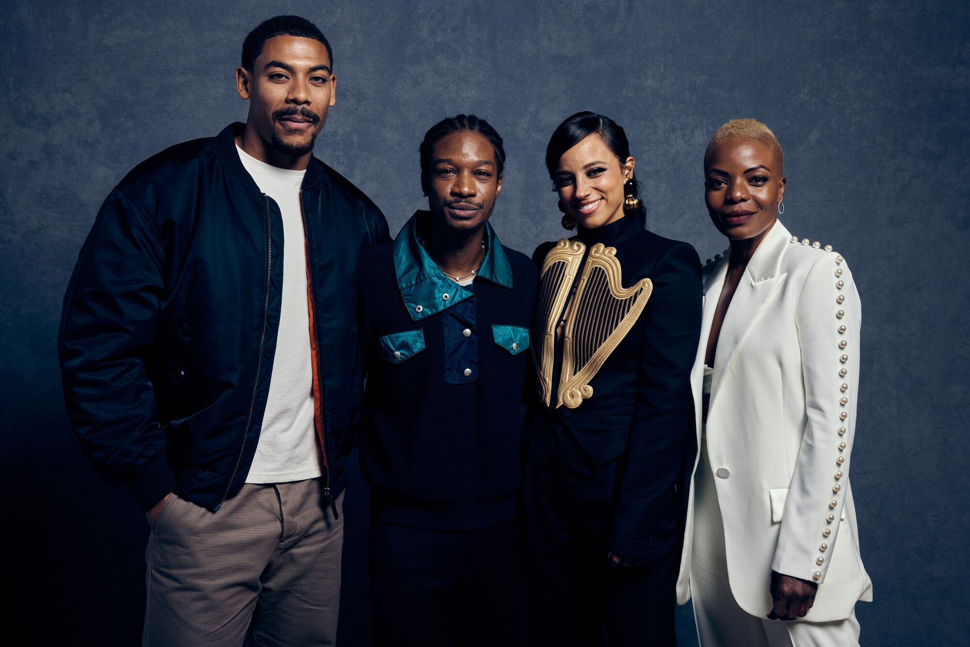 Two men and two women stand and smile.