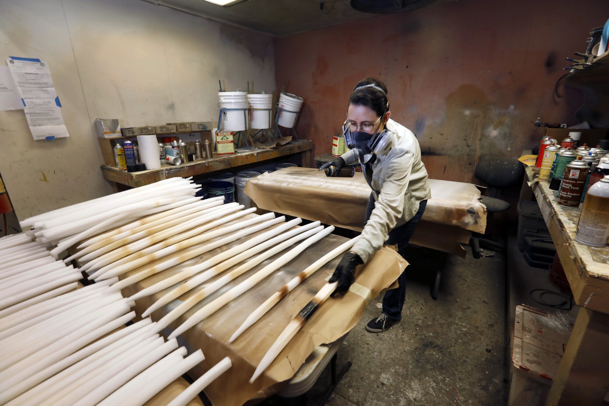 Fabricator Tina Roland paints the quills for a porcupine puppet.