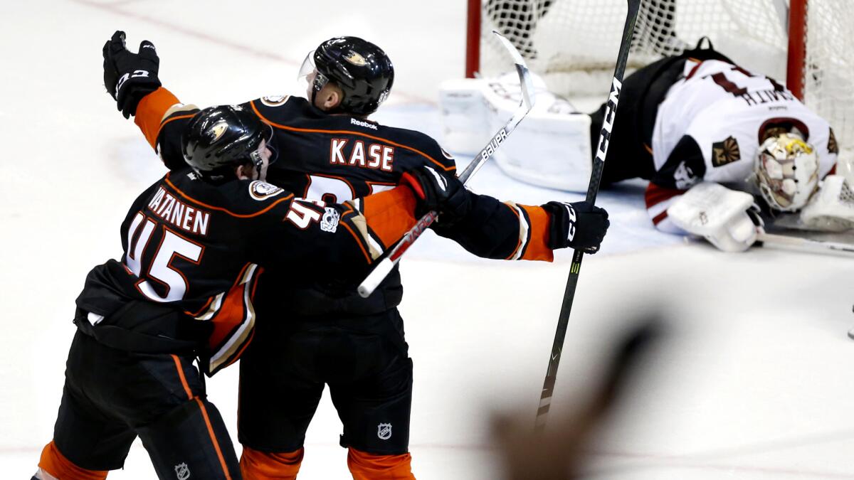 Anaheim's Sami Vatanen (45) and Ondrej Kase celebrate after Kase scored the winning goal against Phoenix goalie Mike Smith in overtime Friday night.