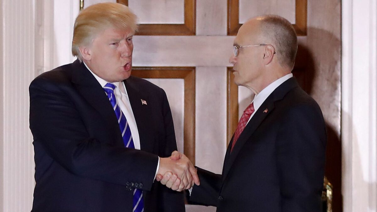 Then-President-elect Donald Trump in November greets Andrew Puzder, his pick to head the Labor Department.