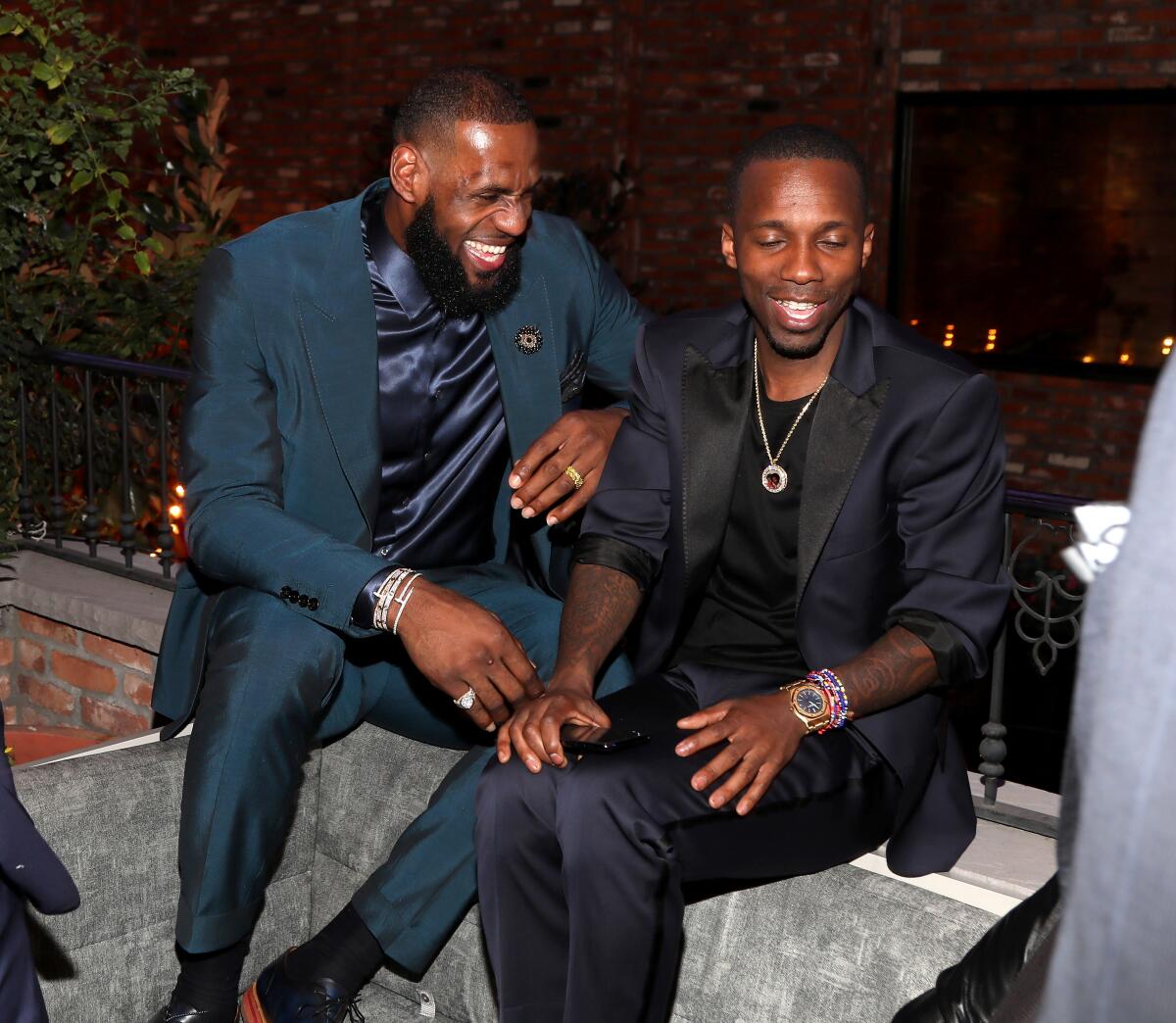 Lebron James and Rich Paul sit and laugh during the Klutch Sports Group's "More Than A Game" dinner 