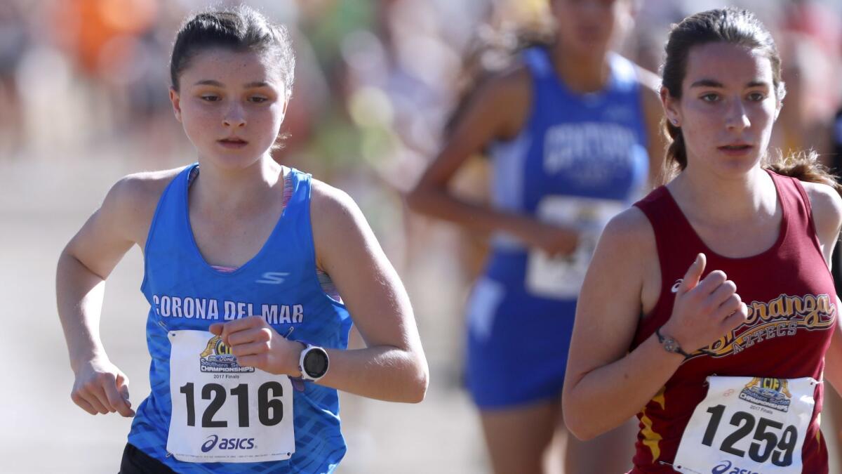 Corona del Mar High’s Annabelle Boudreau, left, seen competing on Nov. 18, 2017, ran 17 minutes 58.2 seconds to win the CIF Southern Section Division 3 girls' cross-country preliminary at the Riverside City Cross-Country Course on Friday.