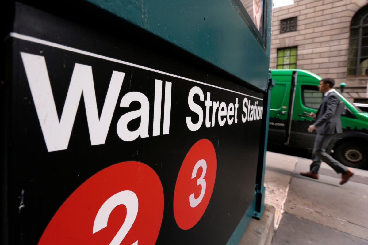 In this April 5, 2018, file photo, a sign for a Wall Street subway station is shown. 