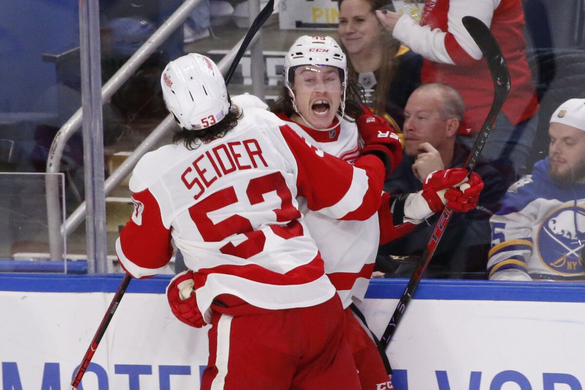 Detroit Red Wings left wing Tyler Bertuzzi (59) celebrates his goal with defenseman Moritz Seider (53) during the third period of an NHL hockey game against the Buffalo Sabres, Saturday, Nov. 6, 2021, in Buffalo, N.Y. (AP Photo/Jeffrey T. Barnes)