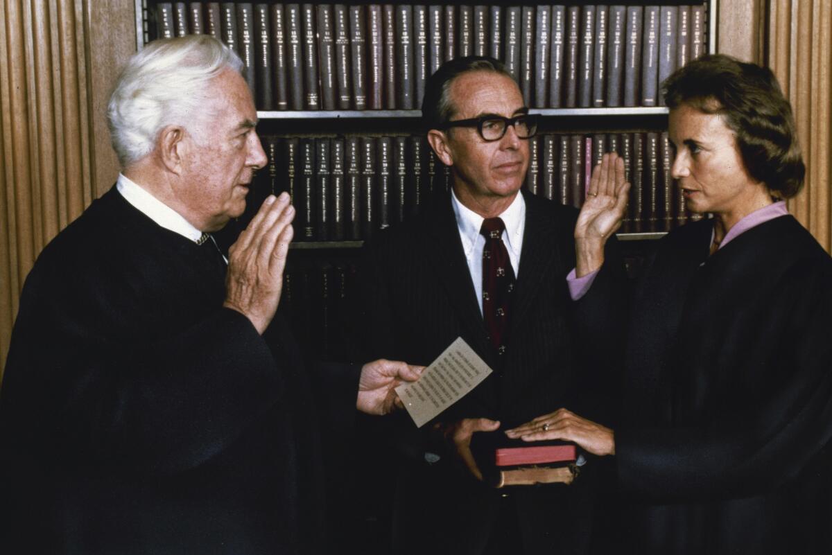 Justice Sandra Day O'Connor, the first woman on the Supreme Court, takes the oath of office on Sept. 25, 1981. 