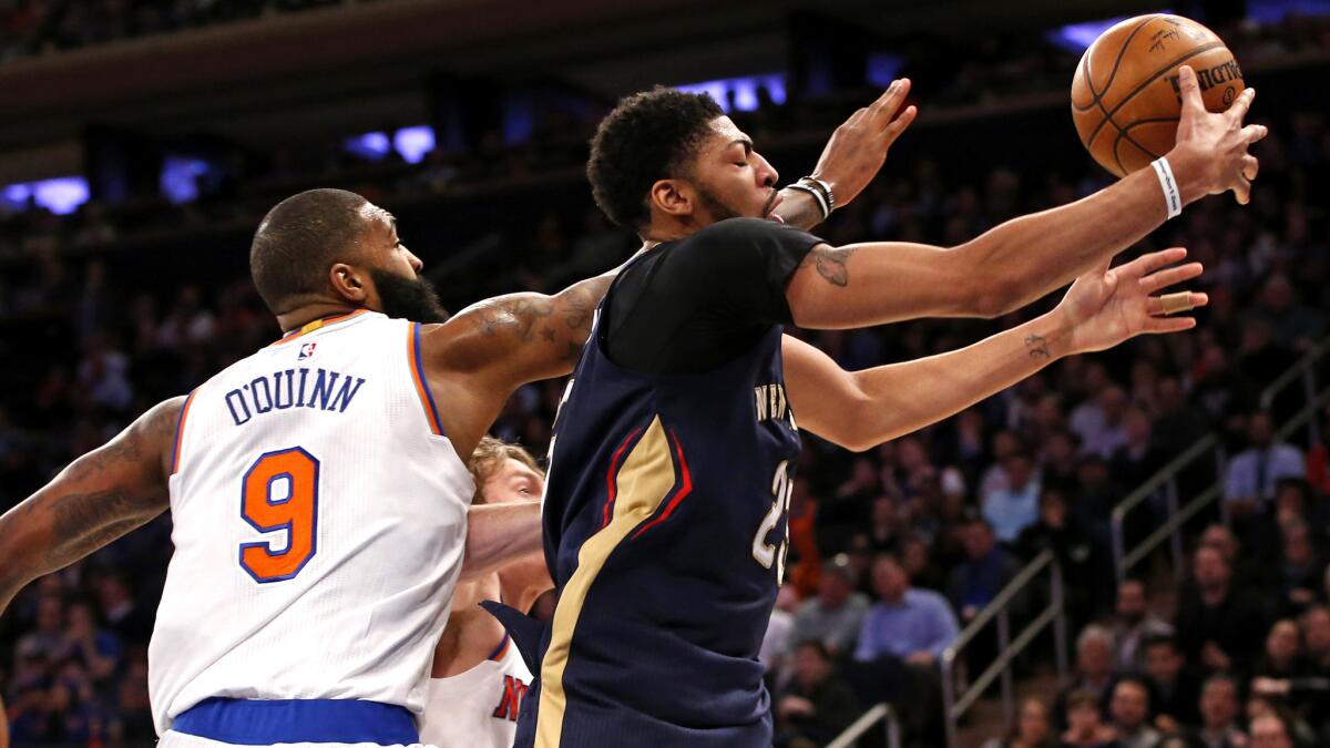 Pelicans forward Anthony Davis battles for a rebound against center Kyle O'Quinn (9) and a Knicks teammate during the second half Monday.