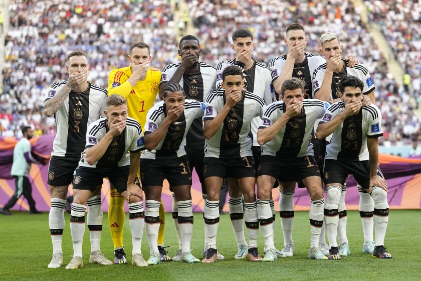FILE - Players from Germany pose for the team photo as they cover their mouth during the World Cup group E soccer match between Germany and Japan, at the Khalifa International Stadium in Doha, Qatar, Wednesday, Nov. 23, 2022. (AP Photo/Ebrahim Noroozi)