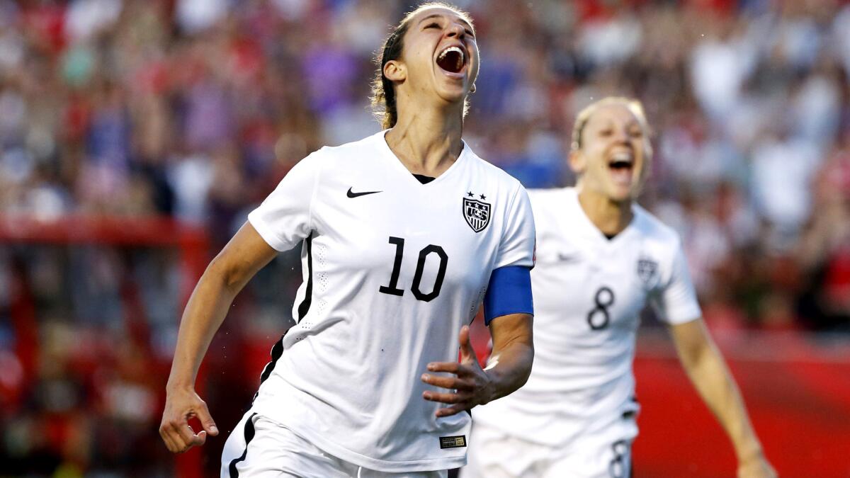 U.S. midfielder Carli Lloyd (10) and forward Amy Rodriguez (8) celebrate after Lloyd scored against China six minutes into the second half of a Women's World Cup quarterfinal game.