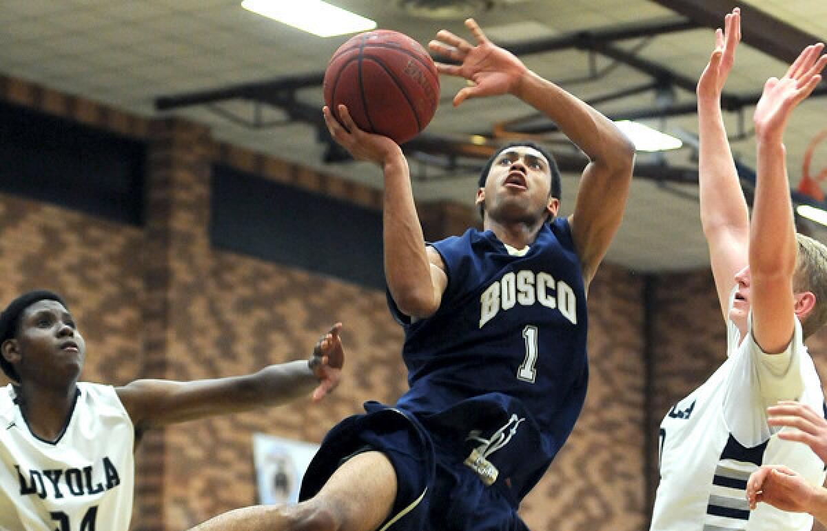 St. John Bosco's Tyler Dorsey drives to the basket between Loyola's Thomas Welsh, right, and Joshua Lavergne during a Mission League game this season.