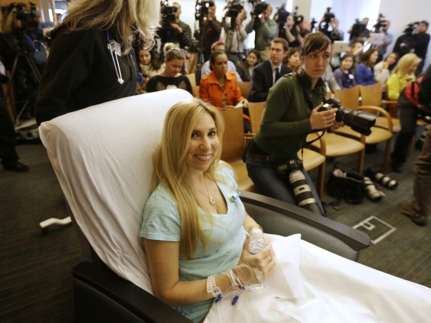 Heather Abbott of Newport, R.I., is wheeled into a news conference at Brigham and Women's Hospital in Boston. Abbott underwent a below-the-knee amputation following injuries she sustained at the Boston Marathon bombings.