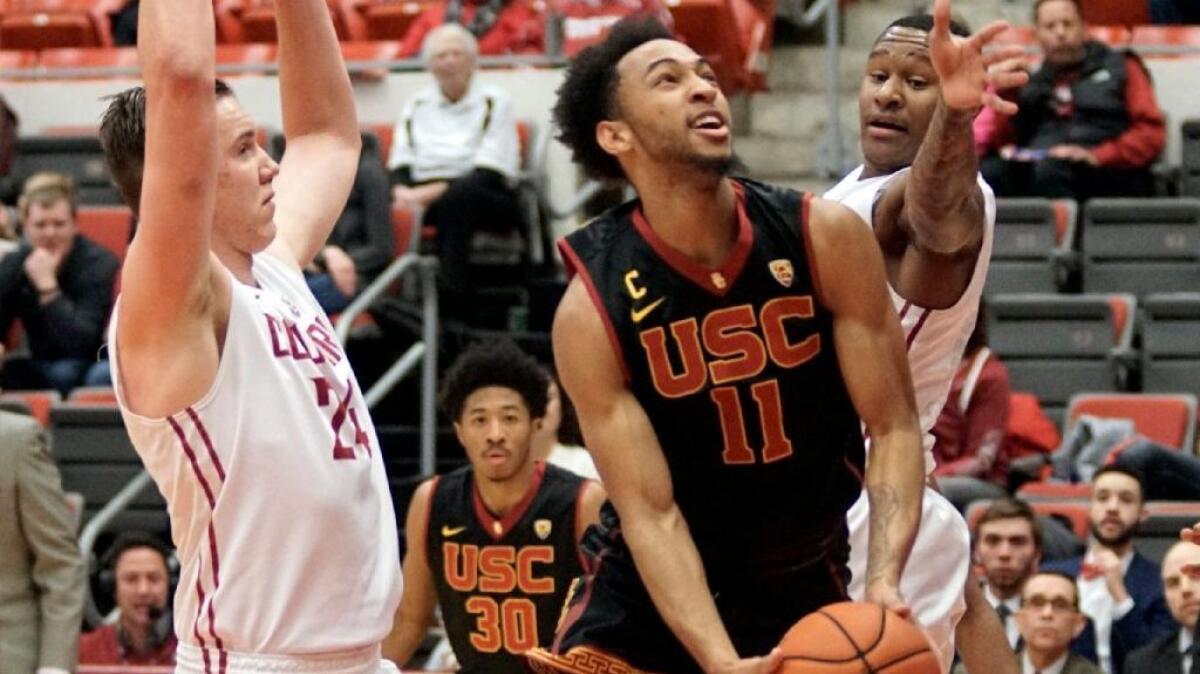 USC guard Jordan McLaughlin splits a pair of Washington State defenders during the first half of a game on Feb. 4.