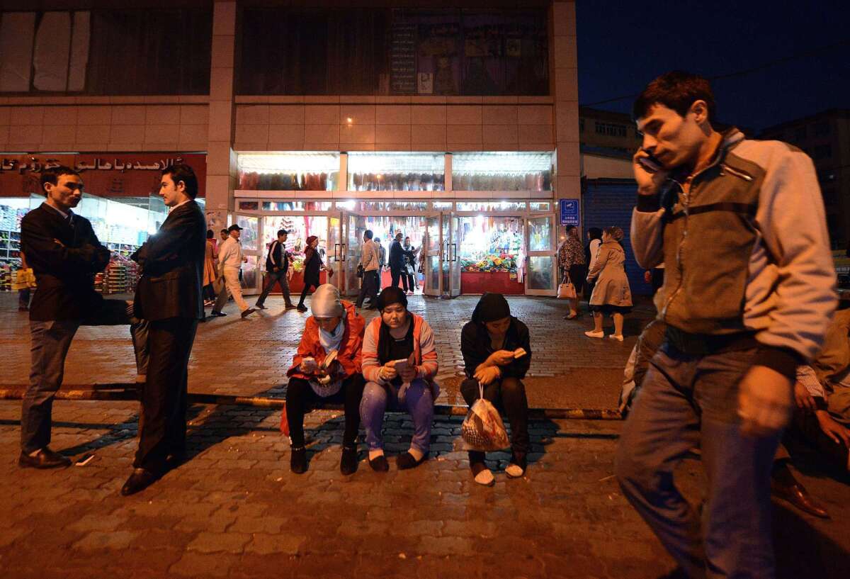 Uighurs rest near the Grand Bazaar in Urumqi, capital of far western China's Xinjiang region.