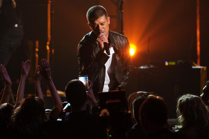 "I was high on Vicodin and alcohol when I showed up at the studio" to record "Blurred Lines" and had little to with writing the song, Robin Thicke testified in a deposition. Above, the singer onstage in Las Vegas in May.