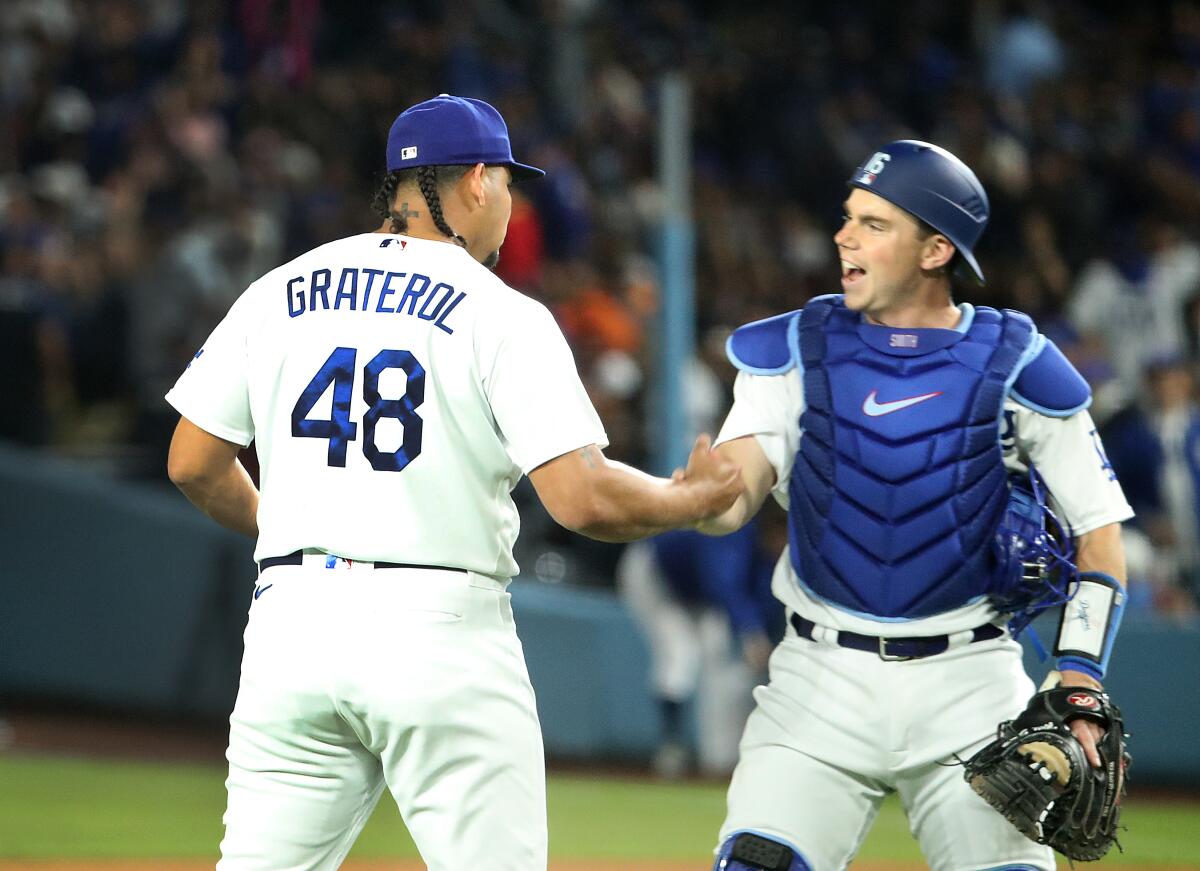 Dodgers relief pitcher Brusdar Graterol celebrates with catcher Will Smith after the Dodgers' 3-2 win.