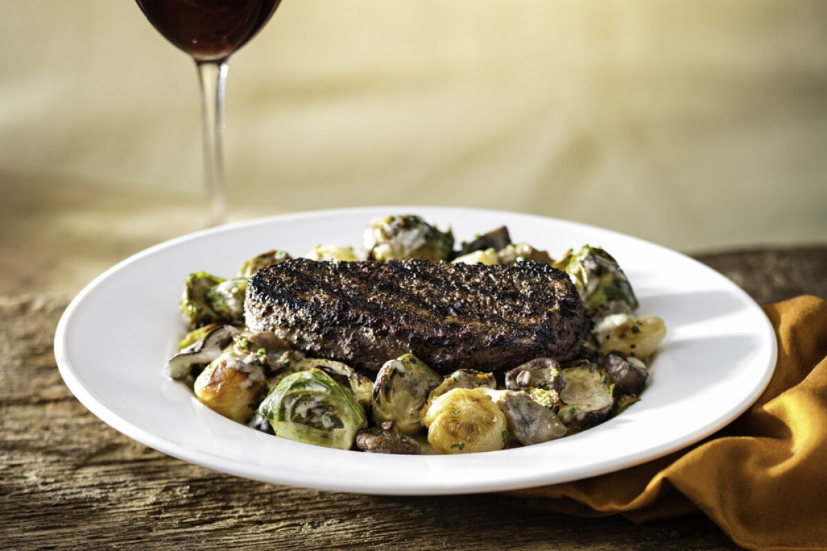 Kona-crusted prime sirloin. with roasted Brussels sprouts and mushrooms in a brandy cream sauce.