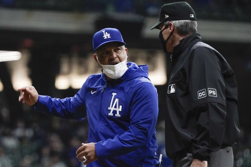 Dodgers manager Dave Roberts argues with first base umpire Angel Hernandez in the eighth inning April 30, 2021, in Milwaukee.