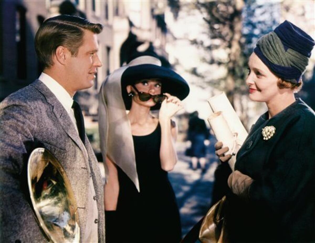 In this image released by Paramount Pictures, George Peppard, left, Audrey Hepburn and Patricia Neal, right, are shown in a scene from, "Breakfast at Tiffany's." (AP Photo/Paramount Pictures)