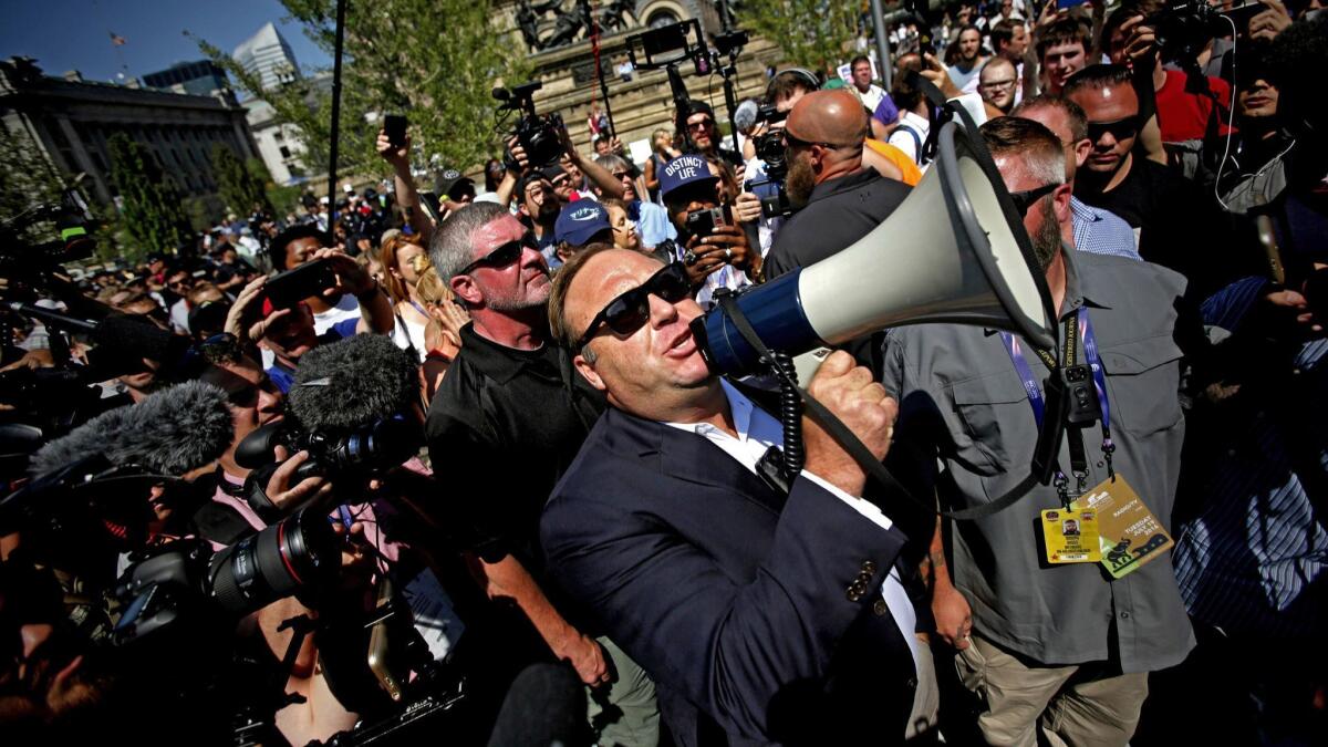 Radio host and conspiracy theorist Alex Jones speaks to crowds outside the Republican National Convention in Cleveland in 2016.