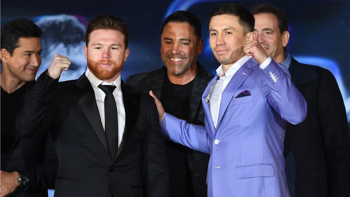 Canelo Alvarez and Gennady Golovkin pose for photos during a news conference on Feb. 27 at L.A. Live to advance their rematch.