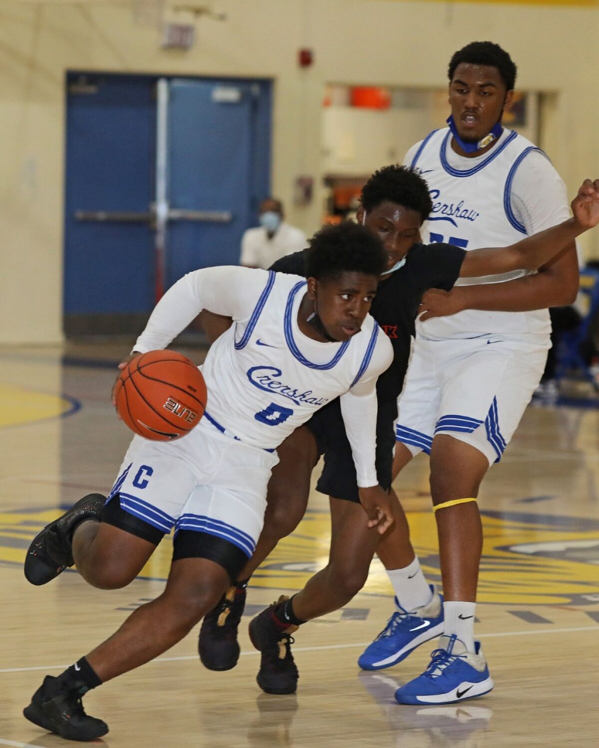 Kevin Bradley of Crenshaw drives against View Park Prep in a high school basketball game.