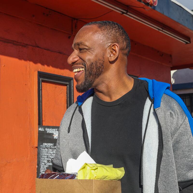 Los Angeles, CA - February 8: James Paschall smiles after receiving his tacos and burrito.