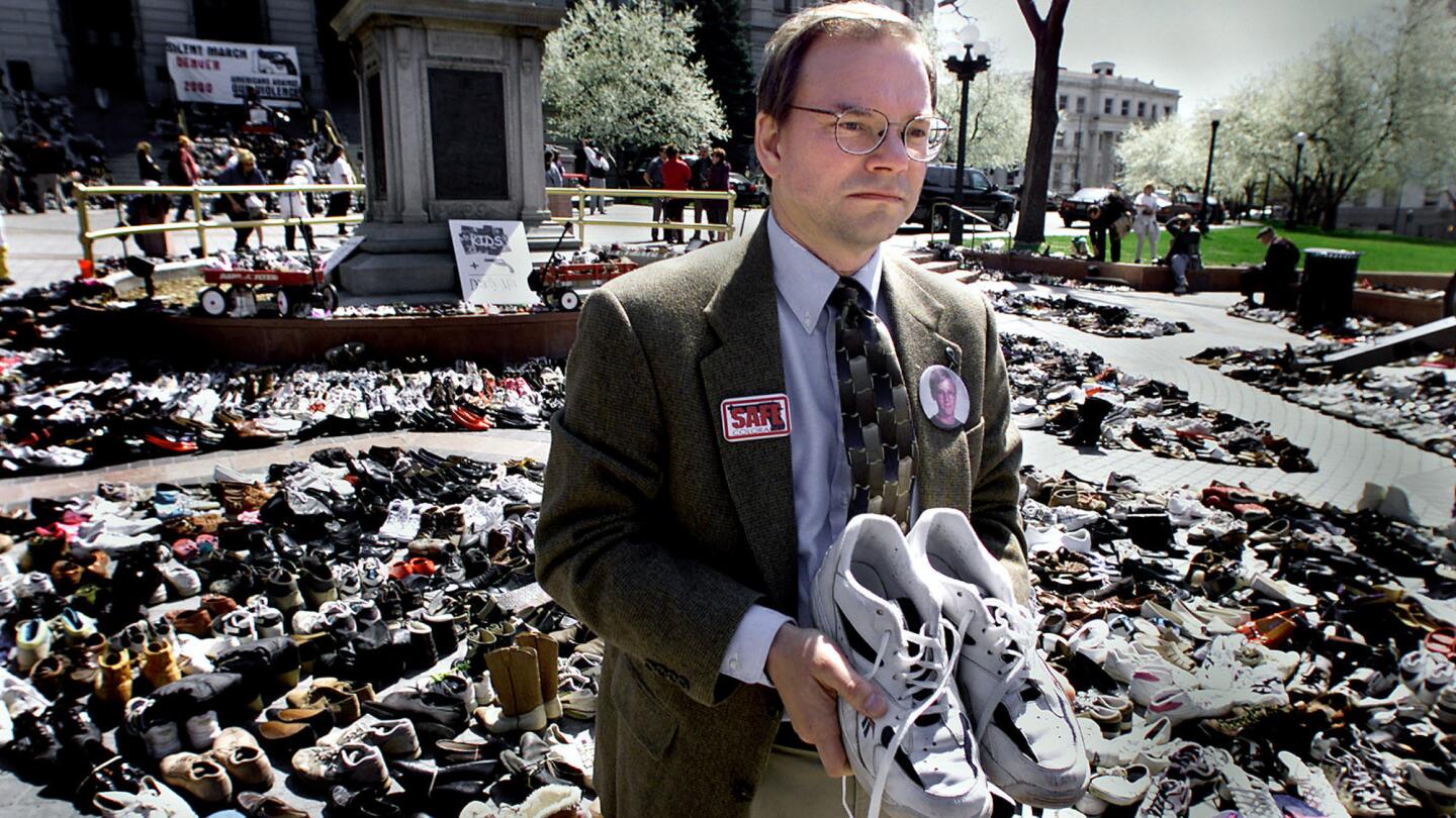 Tom Mauser holds his son's shoes during an anti-gun-violence protest at the Colorado Capitol in Denver in April 2000.