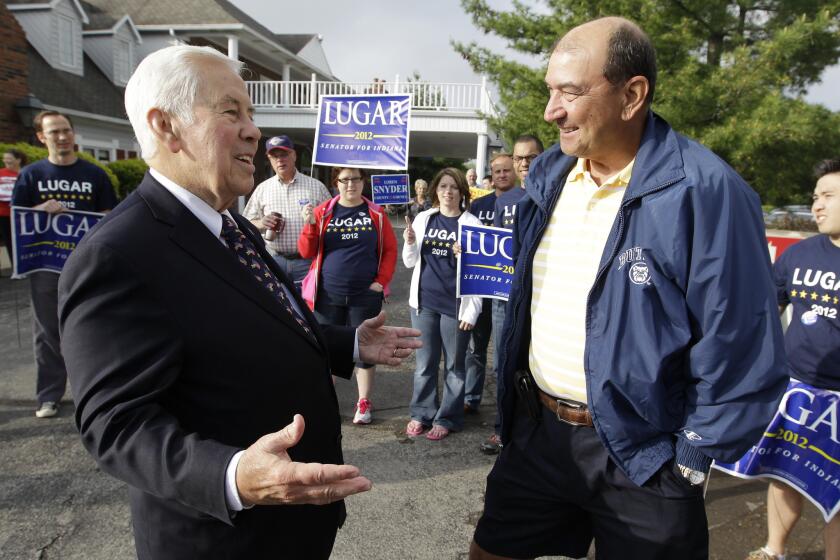 Sen. Richard G. Lugar talks with Joe Purichia before voting in Greenwood, Ind.
