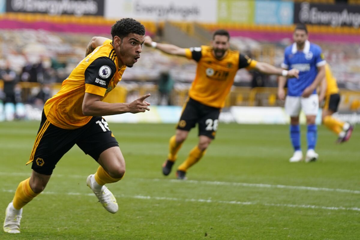Wolverhampton Wanderers' Morgan Gibbs-White, left, celebrates after scoring his side's second goal during the English Premier League soccer match between Wolverhampton Wanderers and Brighton & Hove Albion at the Molineux Stadium in Wolverhampton, England, Sunday, May 9, 2021. (Tim Keeton/Pool via AP)