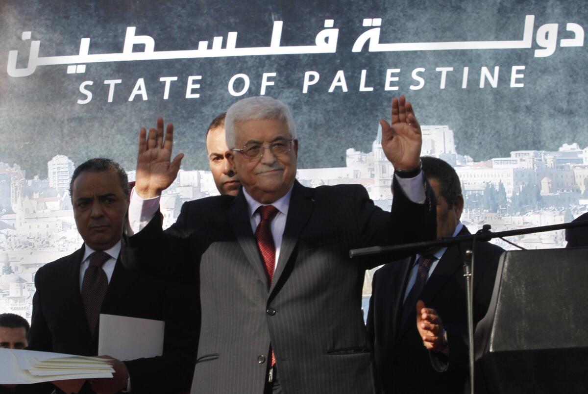 Palestinian Authority President Mahmoud Abbas waves to the crowd in the West Bank city of Ramallah on Dec. 2, 2012, during celebrations of the Palestinian Authority's successful bid to get de facto U.N. statehood recognition. The world body upgraded the Palestinian Authority's status from "nonmember observer entity" to "nonmember observer state" over the objections of the United States and Israel.