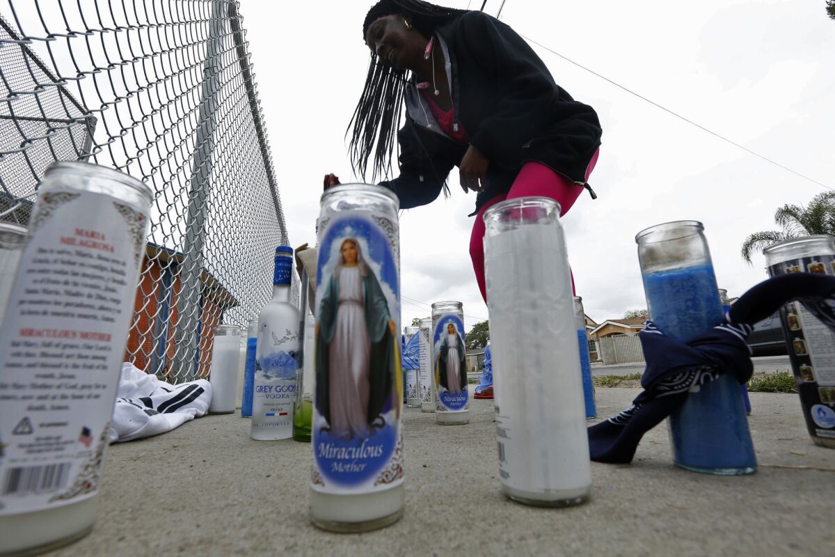Trecie Bryant visits a memorial for shooting victim Anthony Alexander, 26, on West Caldwell Street in Compton. Bryant is friends with the victim's mother.