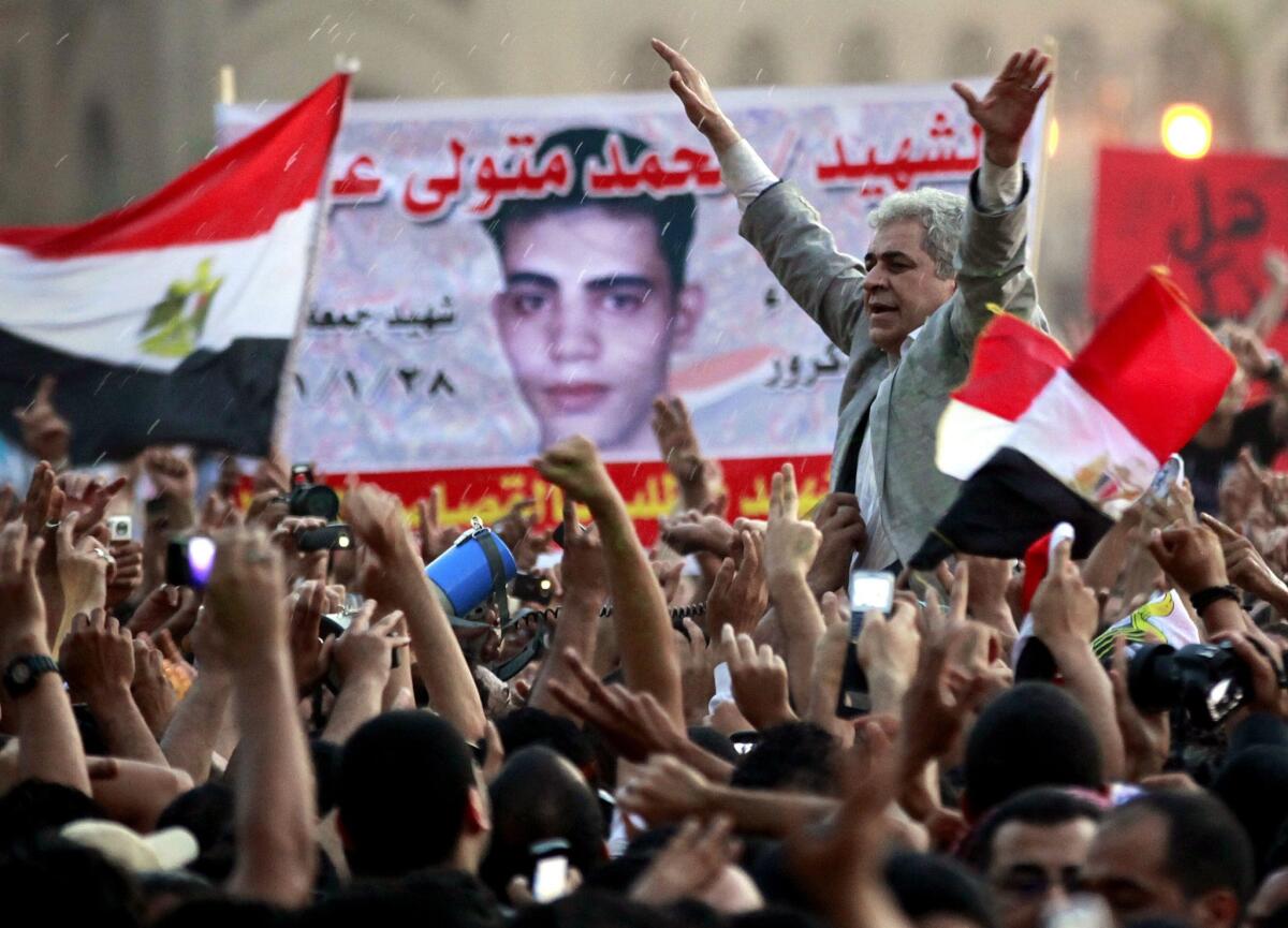 Hamdeen Sabahi, right, then a candidate for the Egyptian presidential elections in 2012, greets protesters at Cairo's Tahrir Square.