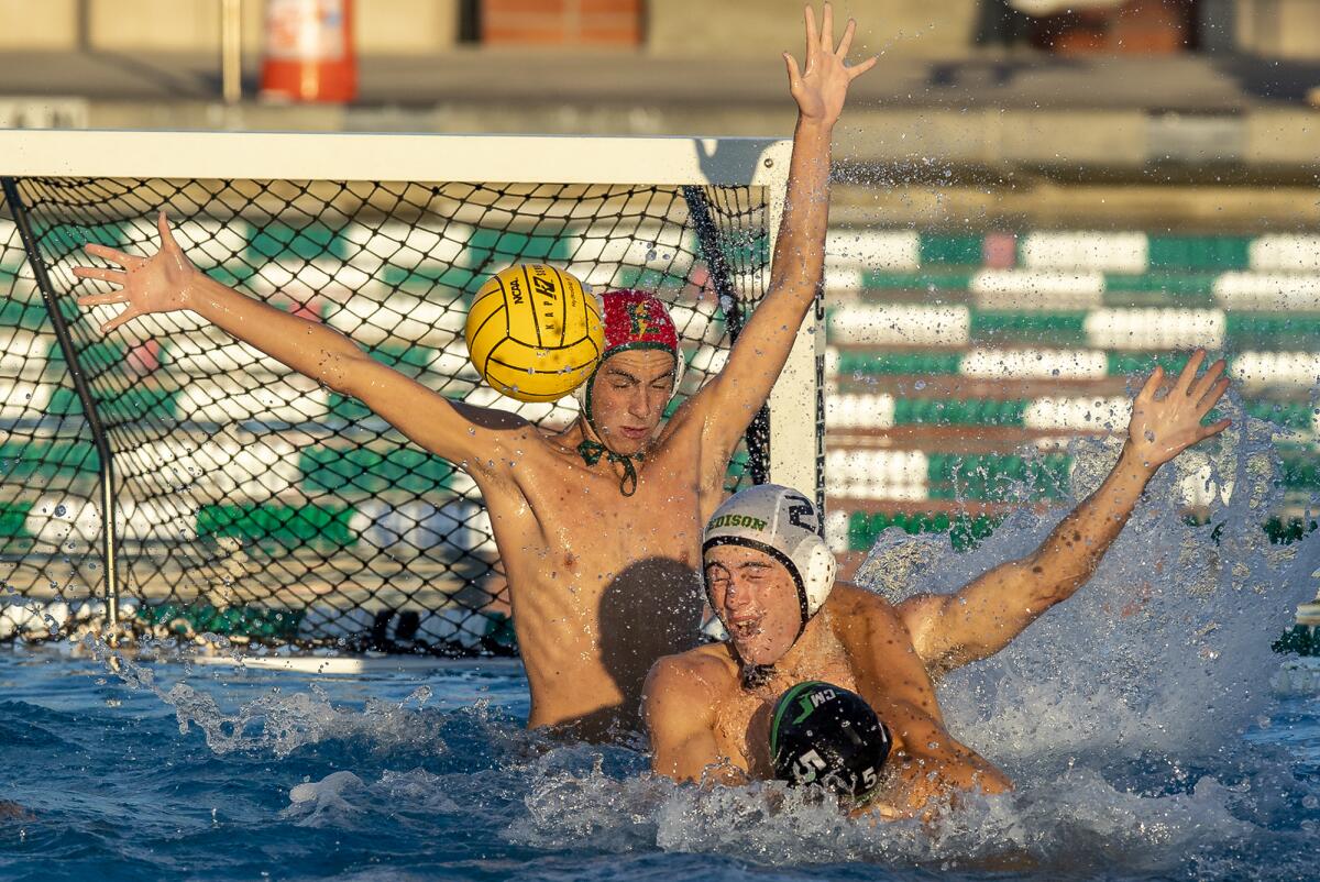 Edison goalkeeper Robert Johnson and Ethan Atwood defend against a shot from Costa Mesa's Wyatt Juelfs. 