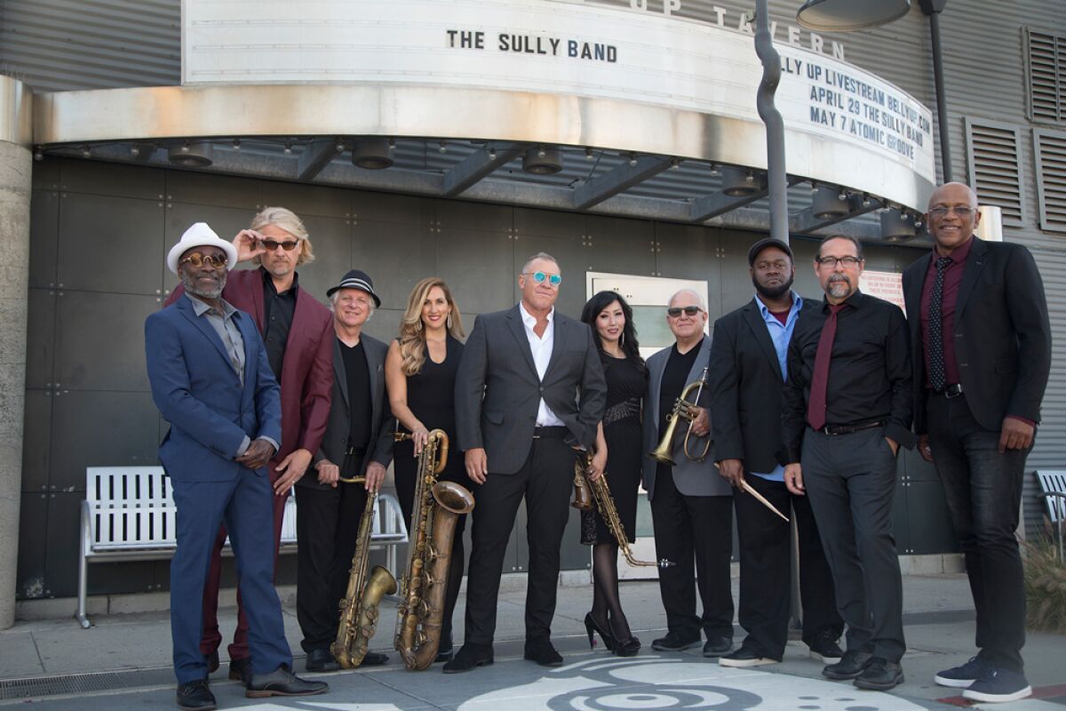 The Sully Band is led by singer John "Sully" Sullivan, who is shown, at center, wearing blue sunglasses.