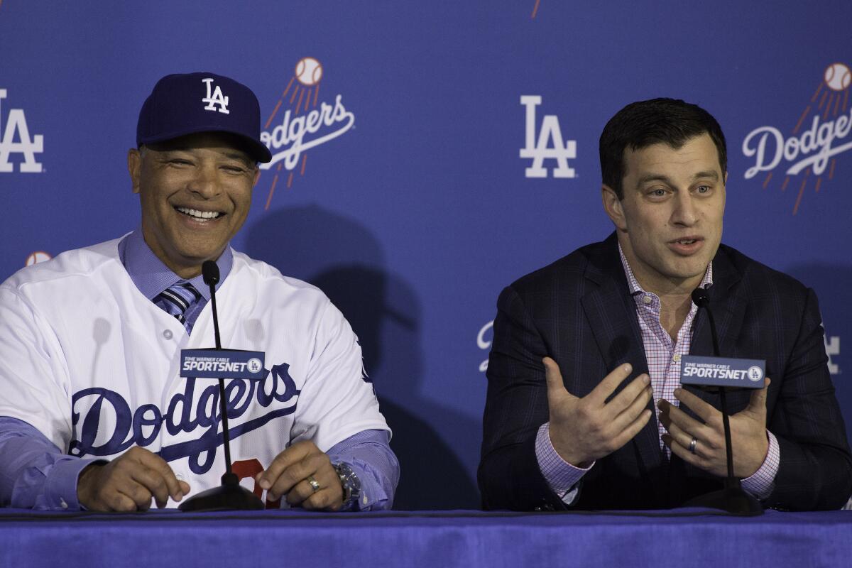 New Dodgers Manager Dave Roberts, left, with President of Baseball Operations Andrew Friedman during an introductory news conference at Dodger Stadium.