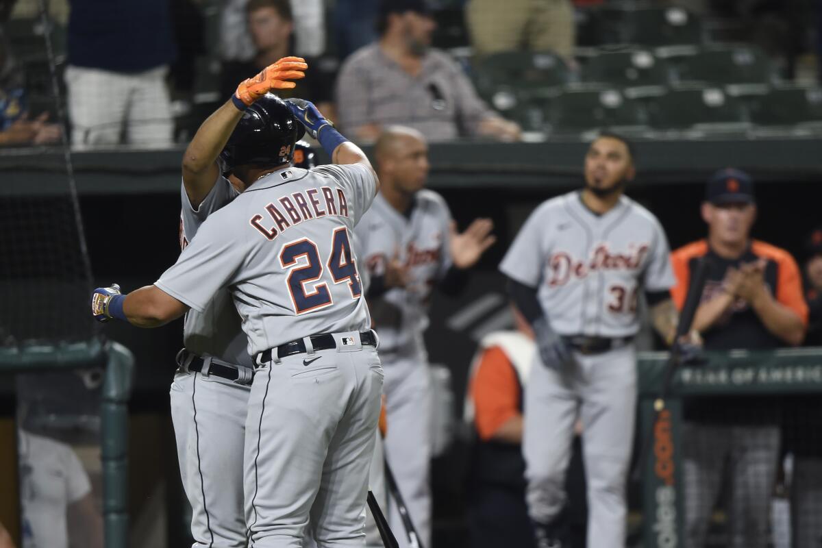Detroit Tigers' Miguel Cabrera is hugged by Jeimer Candelario after hitting his 499th career home run in a baseball game against the Baltimore Orioles, Wednesday, Aug. 11, 2021, in Baltimore. (AP Photo/Gail Burton)