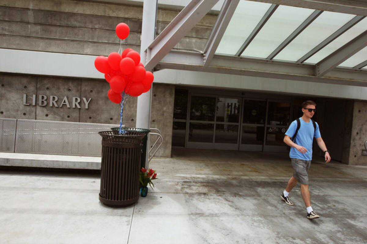 Red balloons and flowers serve as a memorial in June to the students who lost their lives in the shooting rampage at the library of Santa Monica Community College.