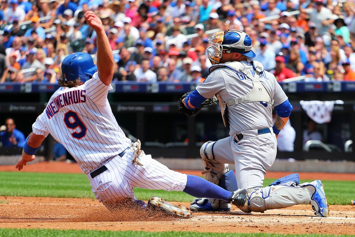 NEW YORK, NY - JULY 26: Kirk Nieuwenhuis #9 of the New York Mets scores a head of the tag by Yasmani Grandal #9 of the Los Angeles Dodgers on teanates Jacob deGrom #48 ground ball to first base in the third inning at Citi Field on July 26, 2015 in Flushing neighborhood of the Queens borough of New York City. (Photo by Mike Stobe/Getty Images) ** OUTS - ELSENT, FPG - OUTS * NM, PH, VA if sourced by CT, LA or MoD **